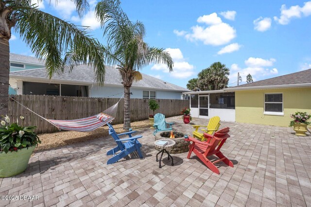 1942 N Daytona Ave, Flagler Beach, FL 32136 - view of patio / terrace with a sunroom and an outdoor fire pit