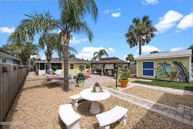 1942 N Daytona Ave, Flagler Beach, FL 32136 - fenced backyard featuring a gazebo and a patio area