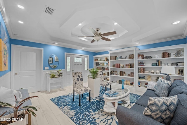 1942 N Daytona Ave, Flagler Beach, FL 32136 - living room featuring a ceiling fan, crown molding, recessed lighting, a tray ceiling, and wainscoting