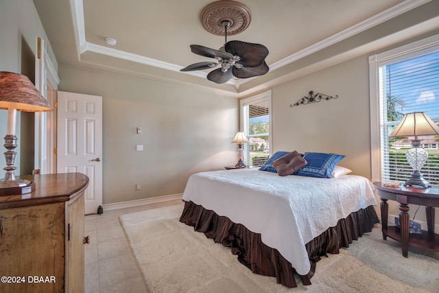 tiled bedroom featuring a tray ceiling, ceiling fan, and ornamental molding