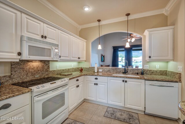 kitchen featuring white appliances, sink, ceiling fan, light tile patterned floors, and white cabinetry