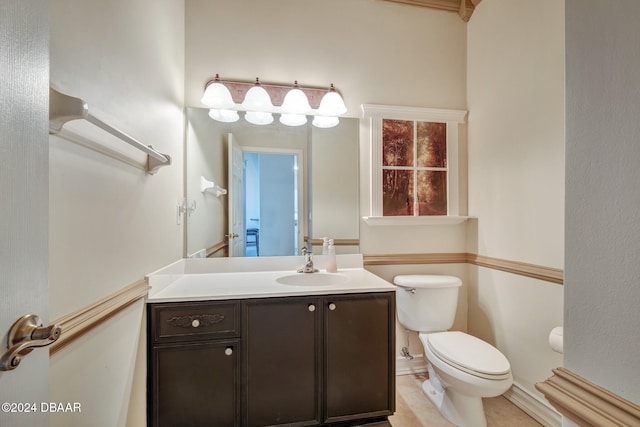 bathroom with tile patterned flooring, vanity, and toilet