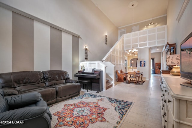 living room with light tile patterned flooring, a high ceiling, and a notable chandelier