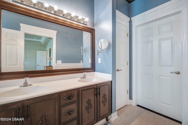 bathroom featuring tile patterned flooring, vanity, and crown molding