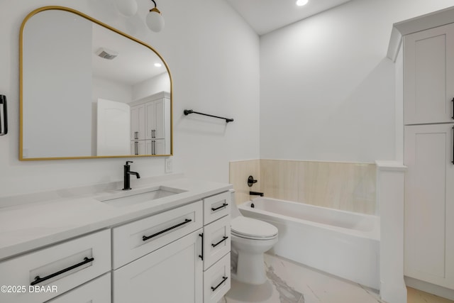 bathroom with a bath, toilet, recessed lighting, marble finish floor, and vanity