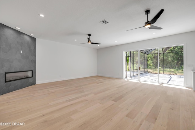 unfurnished living room with ceiling fan, recessed lighting, visible vents, and light wood-style flooring
