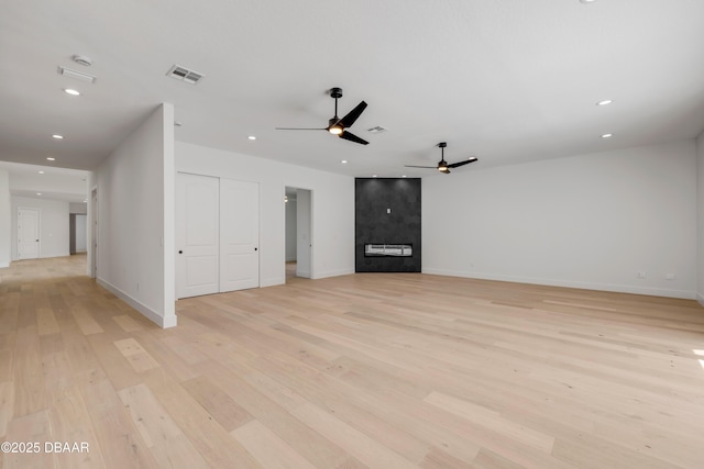 unfurnished living room with recessed lighting, light wood-type flooring, baseboards, a fireplace, and ceiling fan