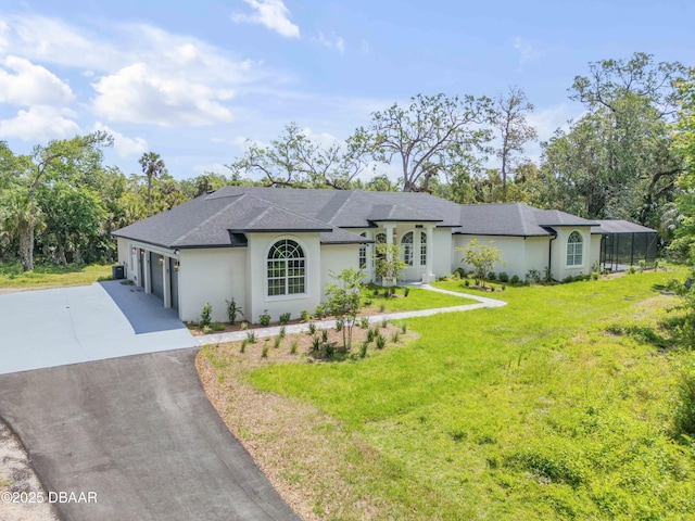 view of front of house featuring roof with shingles, driveway, a garage, a front yard, and stucco siding