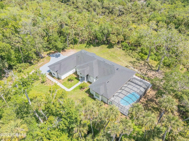 drone / aerial view with a wooded view