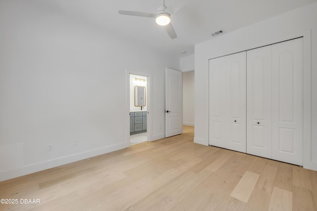 unfurnished bedroom with ensuite bathroom, visible vents, baseboards, light wood-style floors, and a closet