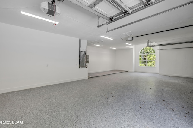 garage with baseboards and a garage door opener