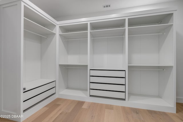 walk in closet featuring wood finished floors and visible vents