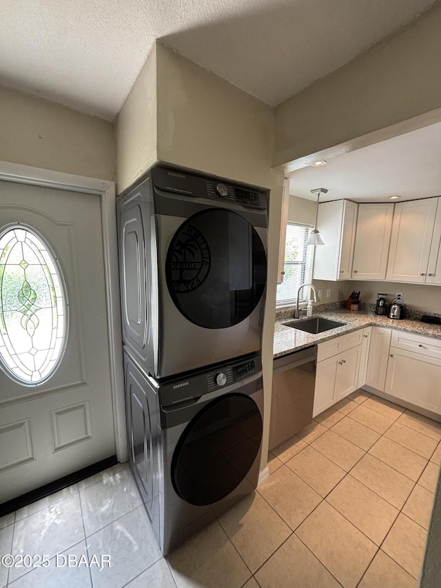 65 Seton Trl Unit 8, Ormond Beach, FL 32176 - laundry area featuring estacked washer and dryer and light tile patterned floors