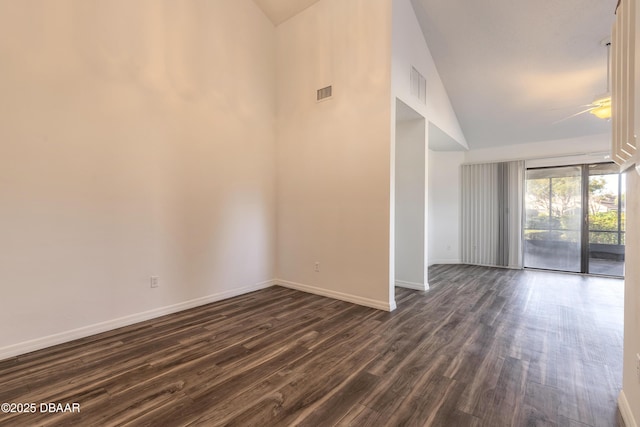 empty room featuring high vaulted ceiling, ceiling fan, and dark wood-type flooring