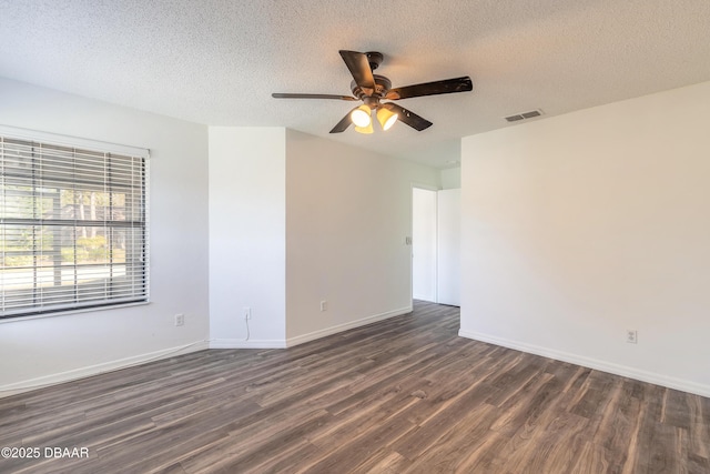 empty room with ceiling fan, a textured ceiling, and dark hardwood / wood-style flooring