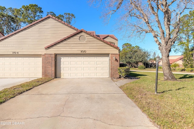 view of property featuring a front lawn and a garage