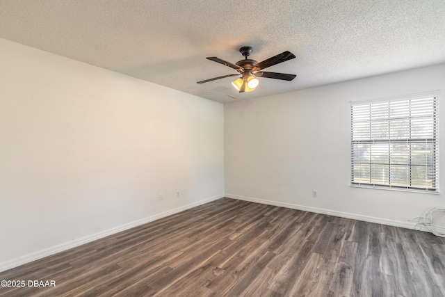 spare room featuring ceiling fan, dark wood-type flooring, and a textured ceiling