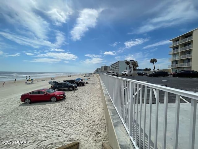 exterior space featuring a water view and a view of the beach