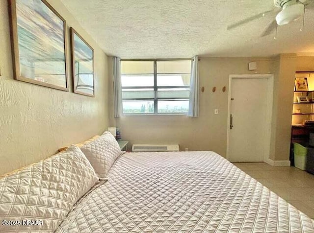 bedroom featuring a textured ceiling, a textured wall, and a ceiling fan