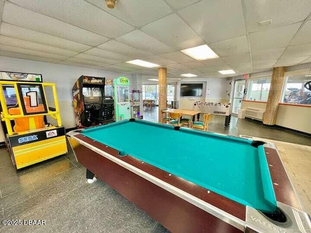 game room featuring plenty of natural light and a drop ceiling