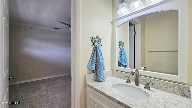 bathroom with ceiling fan, vanity, and ornamental molding