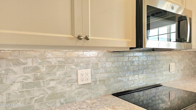 kitchen featuring black electric stovetop and backsplash