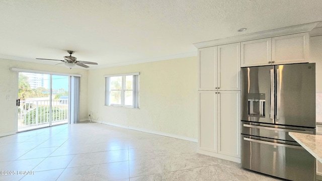 kitchen with crown molding, ceiling fan, stainless steel refrigerator with ice dispenser, a textured ceiling, and white cabinets