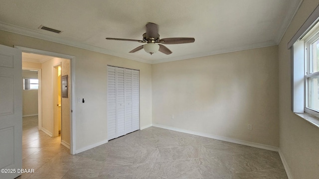 unfurnished bedroom featuring multiple windows, ornamental molding, a closet, and ceiling fan