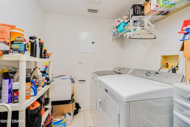 laundry room featuring light tile patterned floors, laundry area, separate washer and dryer, visible vents, and electric panel