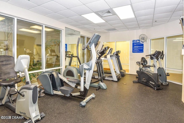 exercise room featuring a paneled ceiling and visible vents