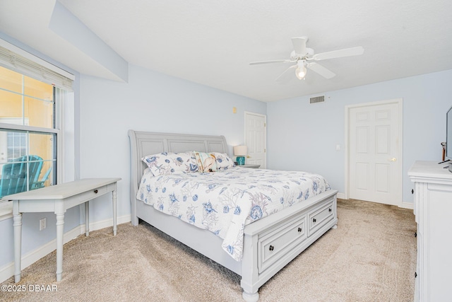bedroom featuring light carpet, baseboards, visible vents, and a ceiling fan