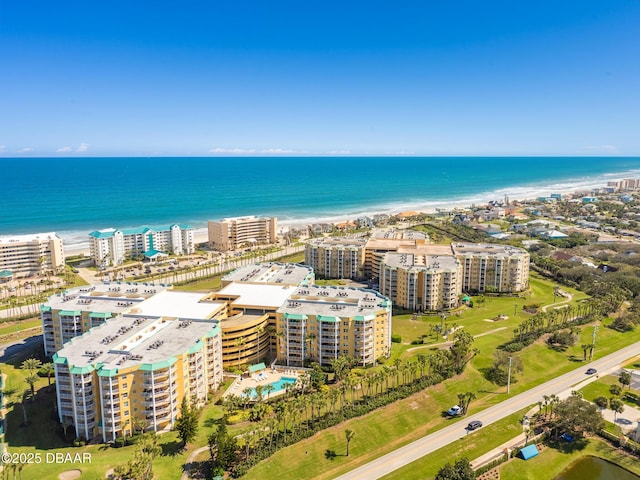 bird's eye view with a water view, a beach view, and a city view