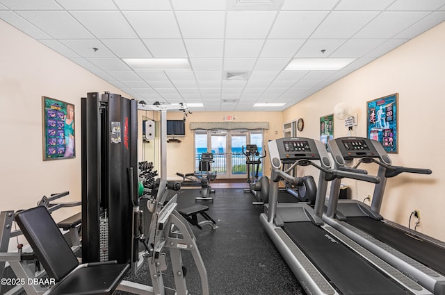 workout area featuring visible vents and a paneled ceiling