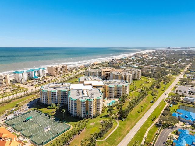 birds eye view of property featuring a view of the beach, a water view, and a city view