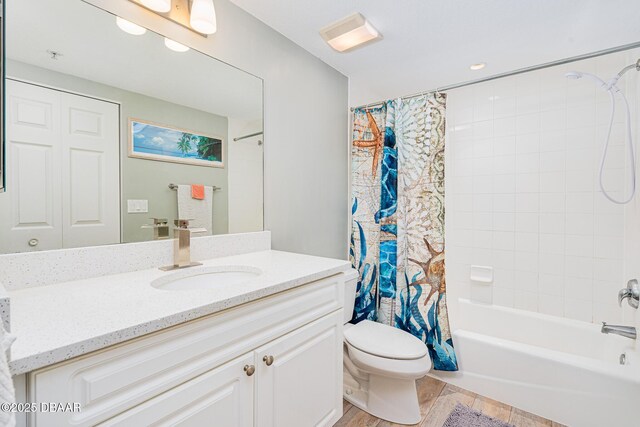 full bathroom featuring toilet, visible vents, vanity, a closet, and shower / bath combination with curtain