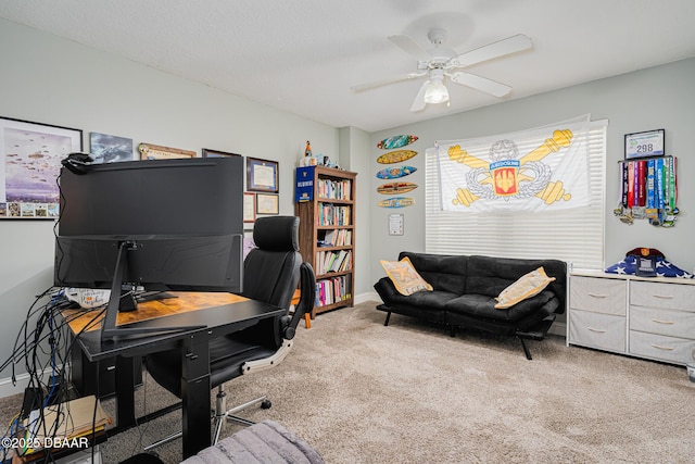 office space featuring a ceiling fan, carpet flooring, and baseboards