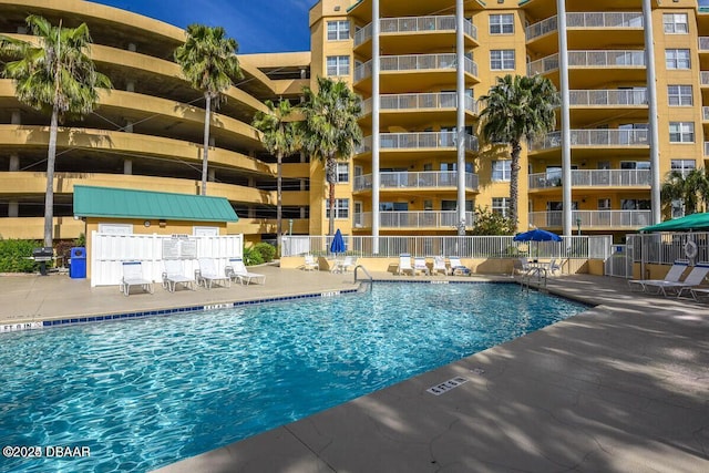 community pool with a grill and a patio
