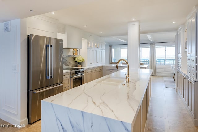 4545 S Atlantic Ave Unit 3604, Ponce Inlet, FL 32127 - kitchen with premium appliances, light stone countertops, recessed lighting, a center island with sink, and light tile patterned floors