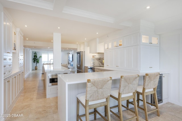4545 S Atlantic Ave Unit 3604, Ponce Inlet, FL 32127 - kitchen with freestanding refrigerator, a spacious island, recessed lighting, white cabinetry, and glass insert cabinets