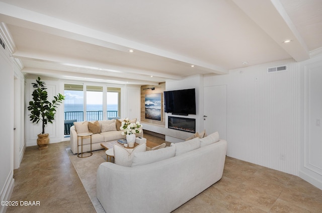 4545 S Atlantic Ave Unit 3604, Ponce Inlet, FL 32127 - living area featuring beamed ceiling, recessed lighting, a glass covered fireplace, and a decorative wall