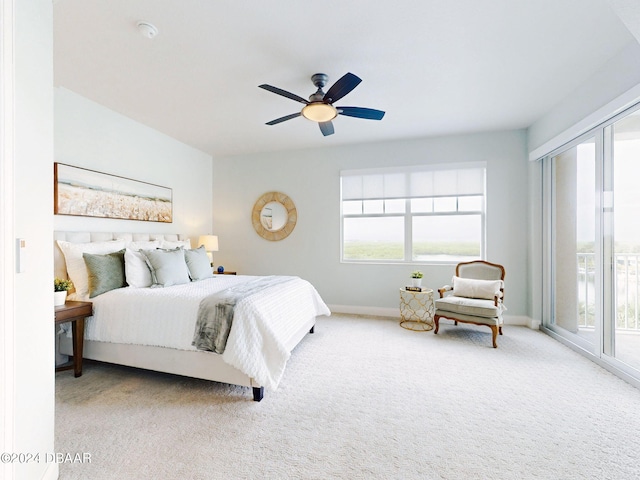 bedroom featuring access to exterior, carpet floors, and multiple windows