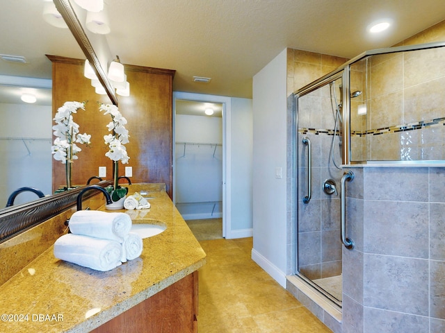 bathroom featuring vanity and a shower with shower door