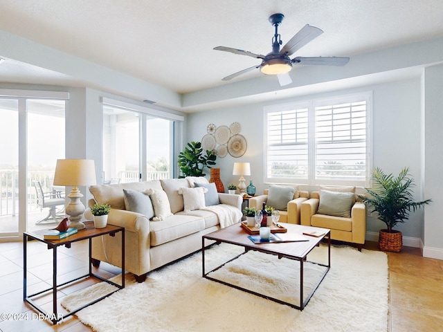 living room featuring ceiling fan, tile patterned flooring, and a healthy amount of sunlight