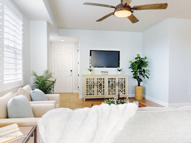 tiled living room featuring ceiling fan