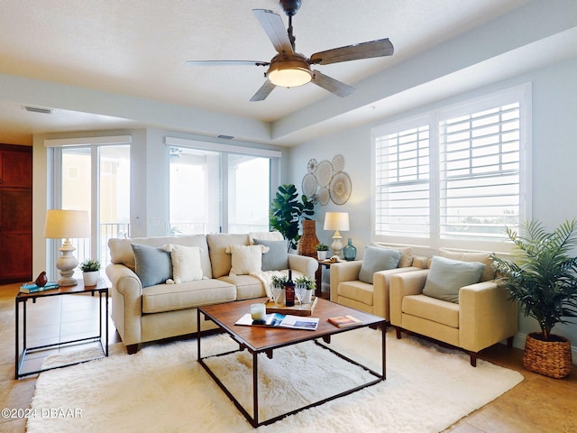 living room featuring ceiling fan and plenty of natural light