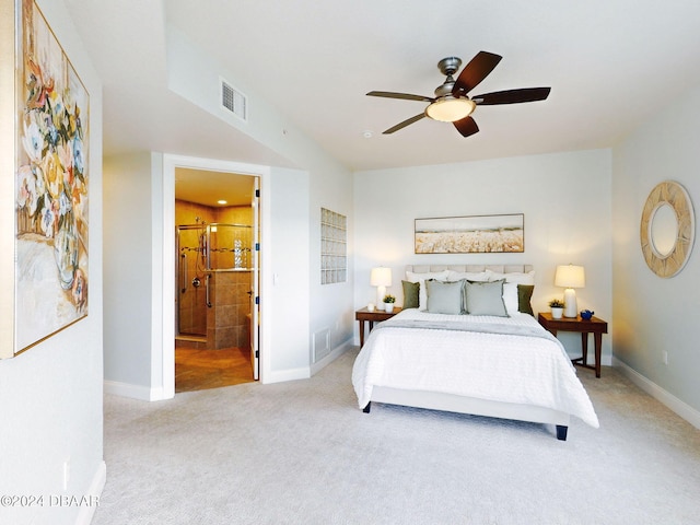 bedroom with connected bathroom, light colored carpet, and ceiling fan