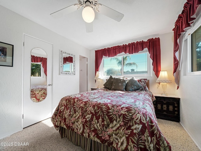 bedroom with speckled floor and a ceiling fan