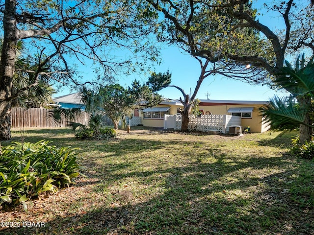 view of yard featuring cooling unit and fence