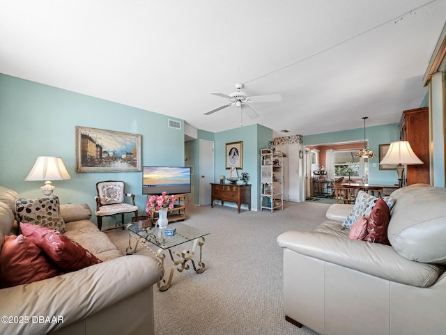 carpeted living room featuring visible vents and ceiling fan