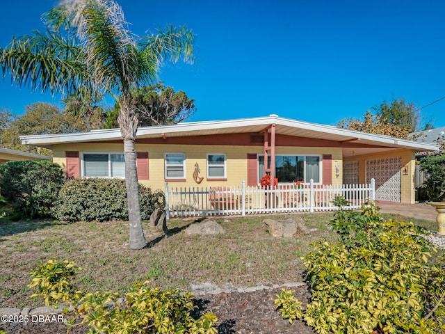 ranch-style home featuring a fenced front yard